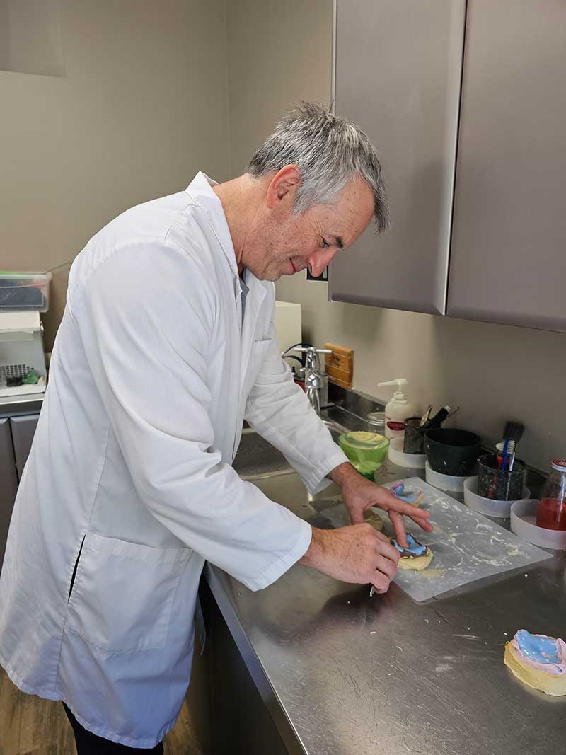 Jeffrey Frasch in clinic making dentures